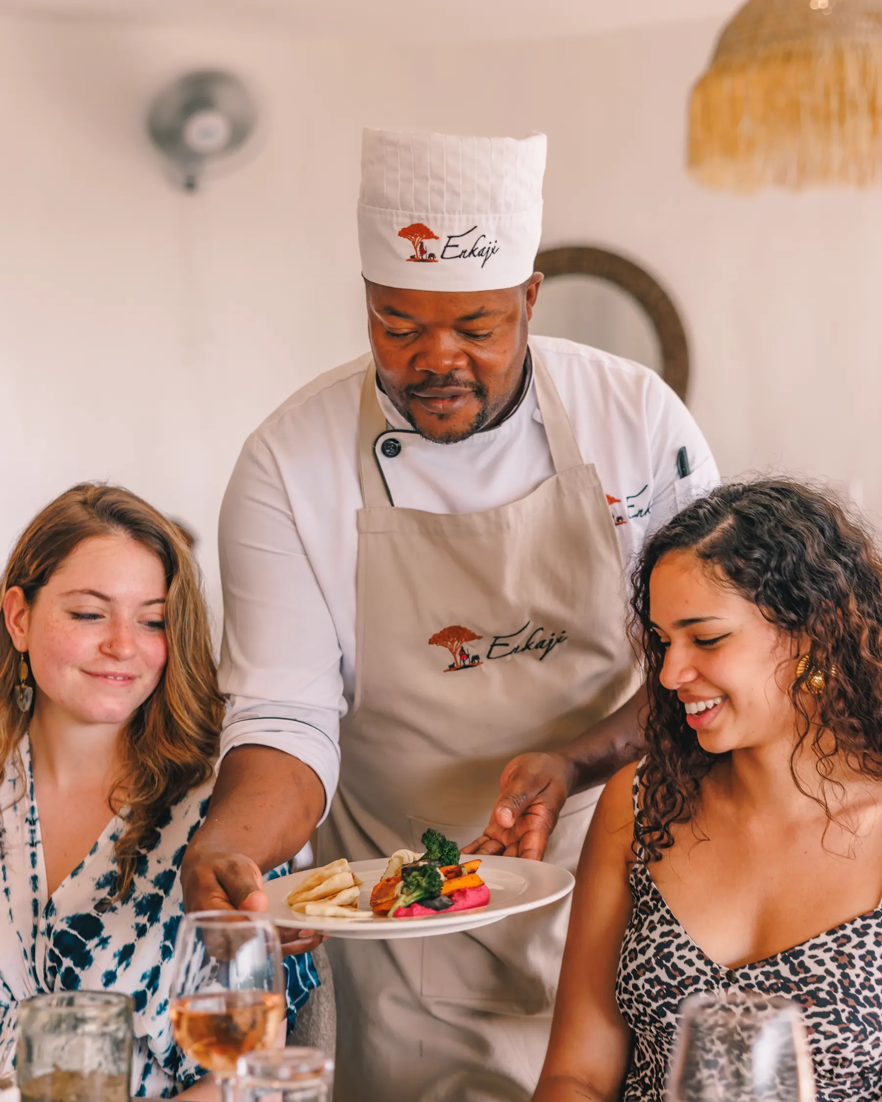 Chef presenting a dish to guests at the table