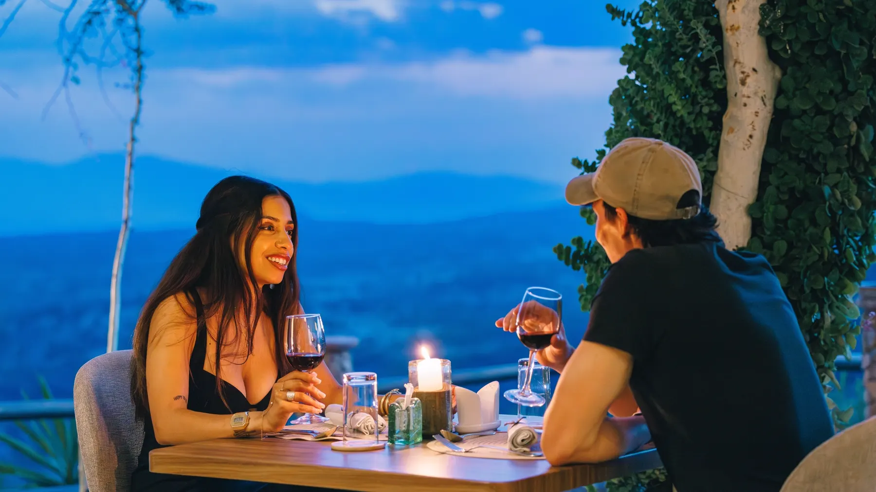 A couple dining above the valley at dusk