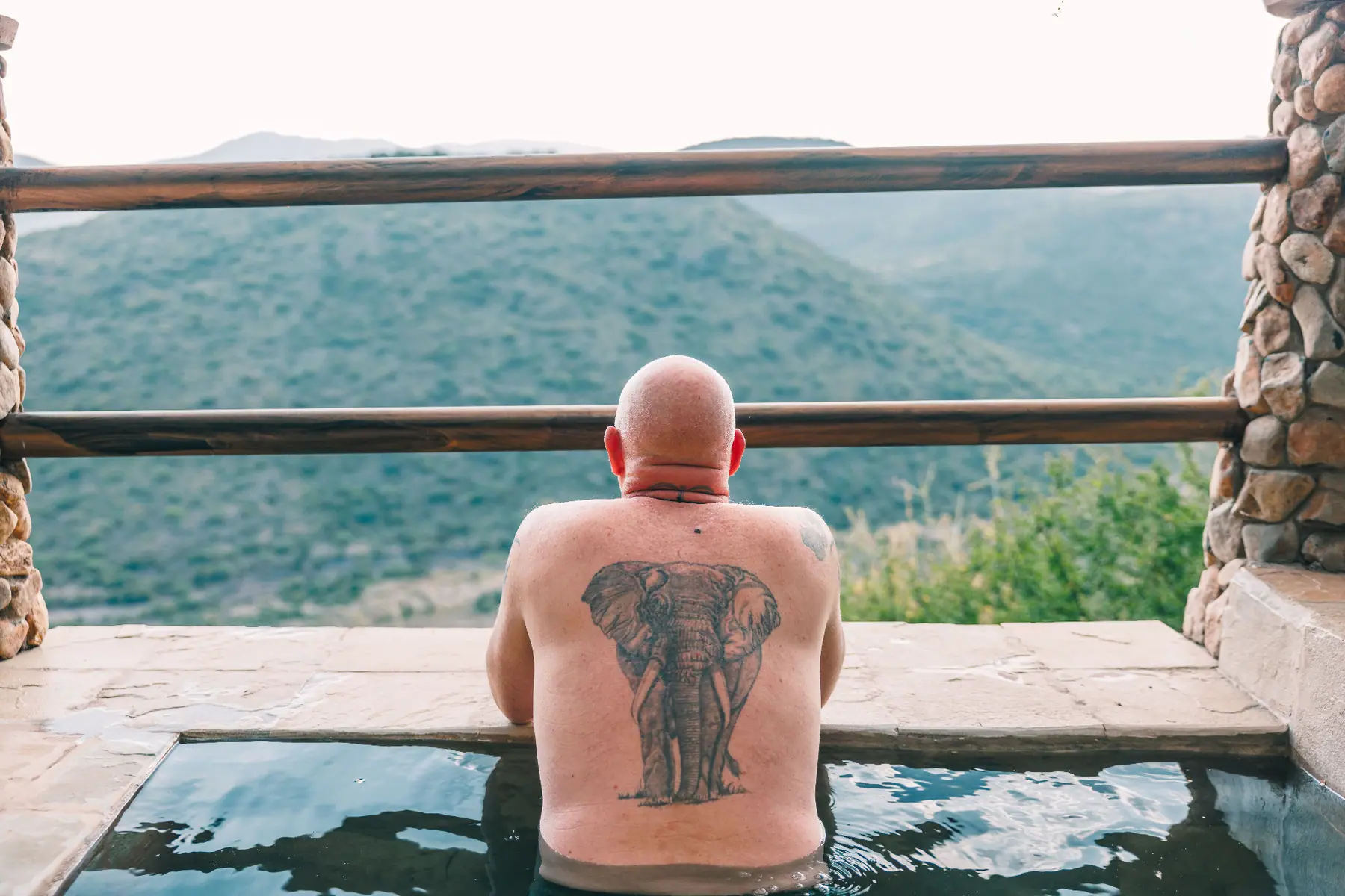 Guest soaking in the plunge pool overlooking the valley